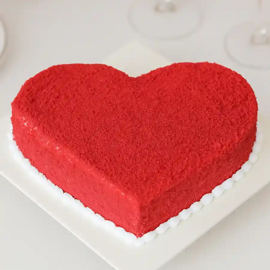Heart-shaped red velvet cake designed for Valentine's Day celebration.