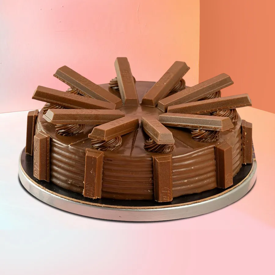 A delicious 1 lb KitKat Chocolate Cake featuring a rich chocolate base and crunchy KitKat pieces, perfect for sharing moments of joy.