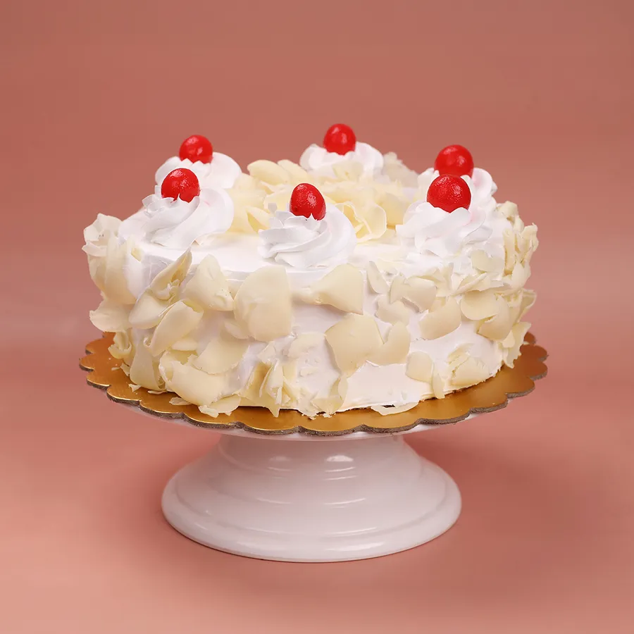 Sumptuous White Forest Cake showcasing fluffy sponge and cream.