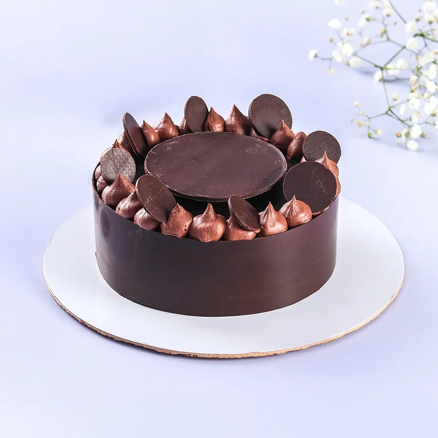 Luxurious Dutch Truffle Cake from Theobroma, showcasing velvety chocolate layers and smooth ganache, perfect for celebrations.