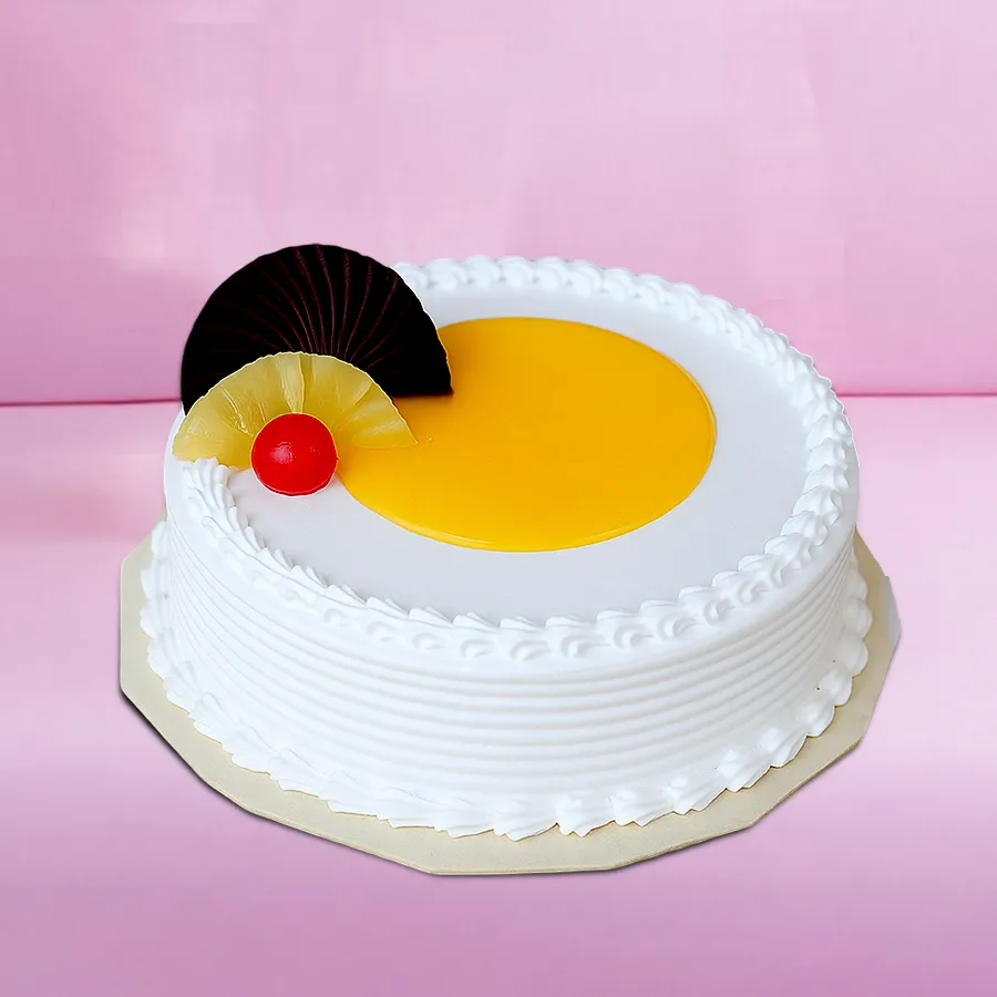 Eggless Fresh Cream Pineapple Cake with pineapple slices on top.