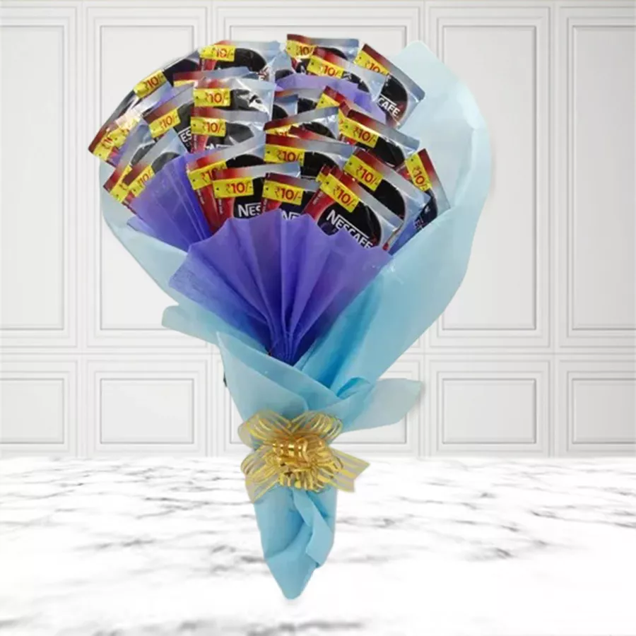 A vibrant bouquet made of 30 Nescafe coffee pouches arranged in blue tissue paper and tied with a golden ribbon.