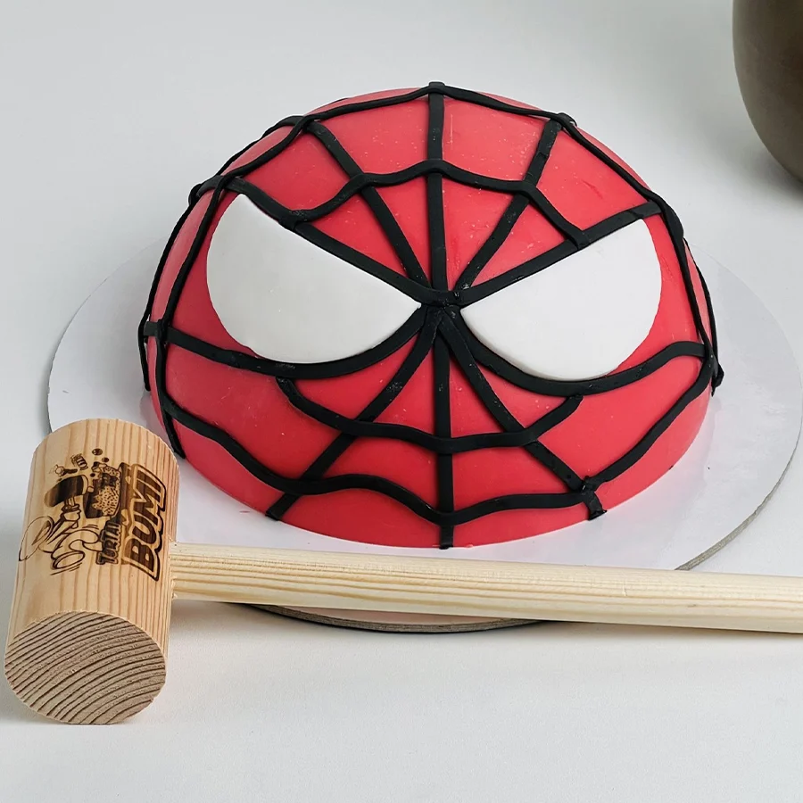 Spidey Smash Cake Adventure with colorful Spiderman design and hammer for smashing fun.