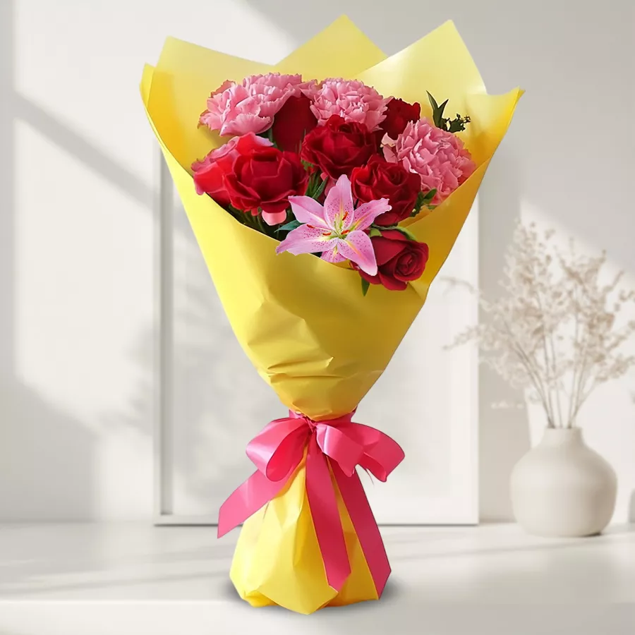 Vibrant floral arrangement with Asiatic Lily, Roses, and Carnations.