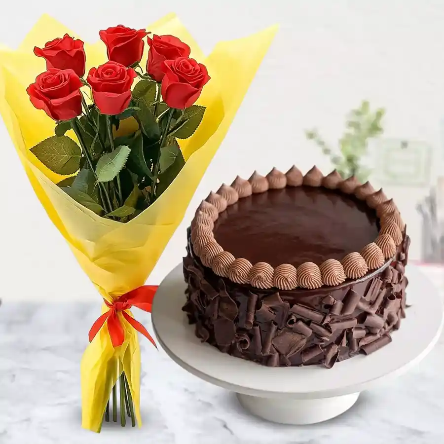 Irresistible chocolate cake paired with a bouquet of six red roses.