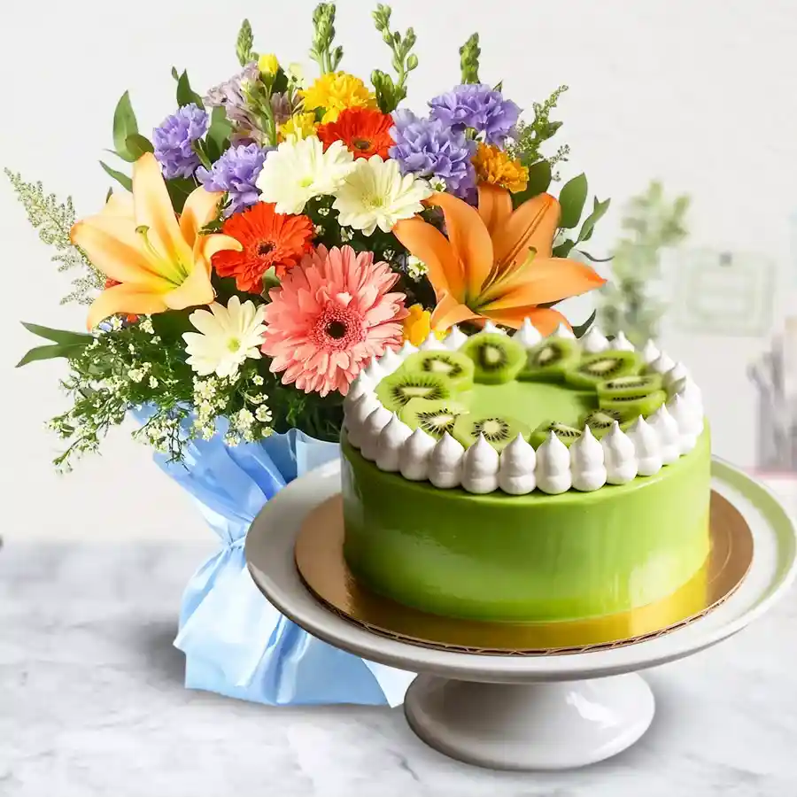 A vibrant bouquet of 12 mixed flowers paired with a 1 kg kiwi cake, perfect for Mother's Day celebrations.