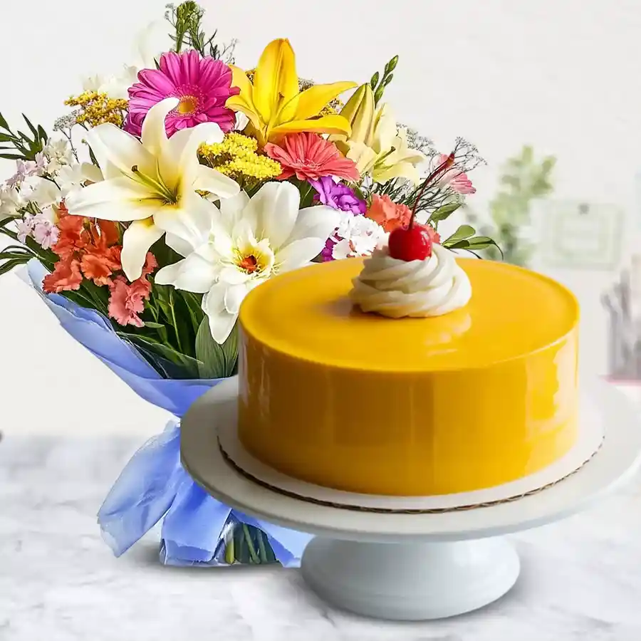 A vibrant 12 mixed flowers bouquet alongside a delicious 1 kg mango cake, ideal for celebrating love and joy.