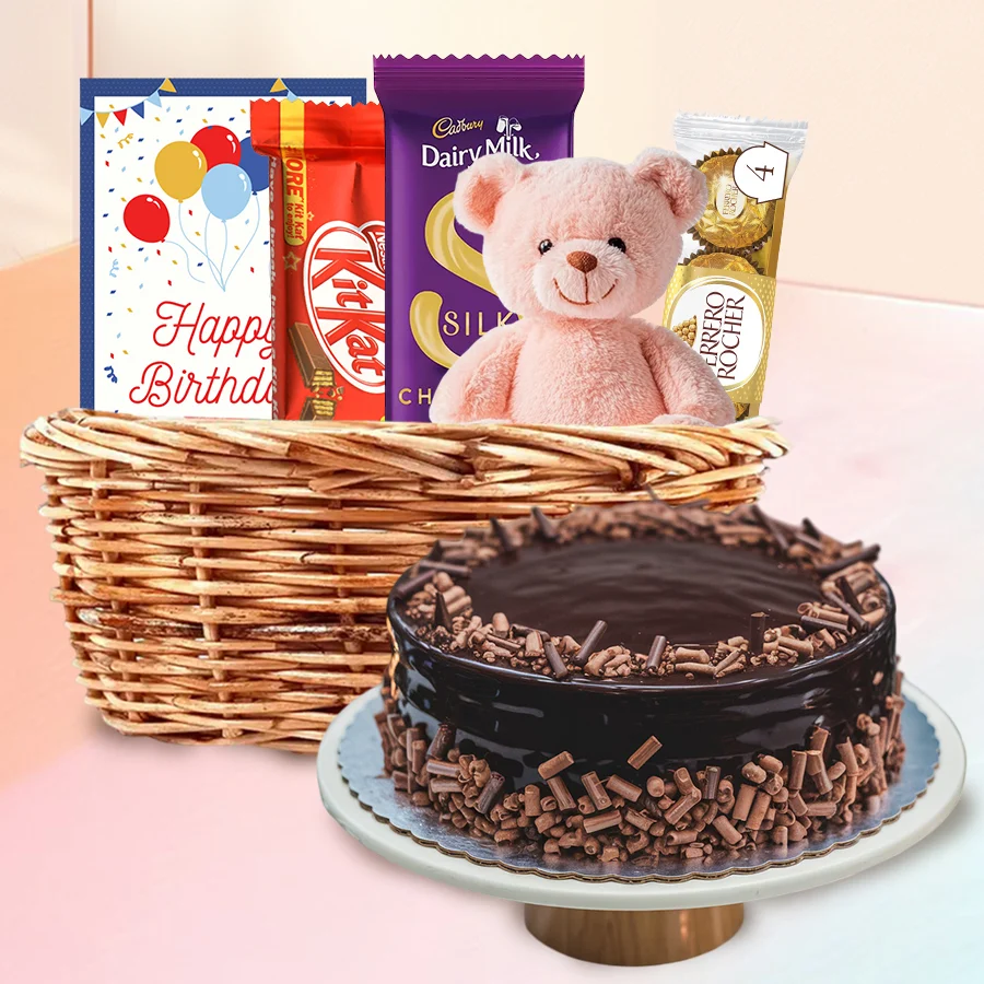 Birthday Joy Basket featuring chocolate cake, teddy bear, and assorted sweets for a joyful celebration.