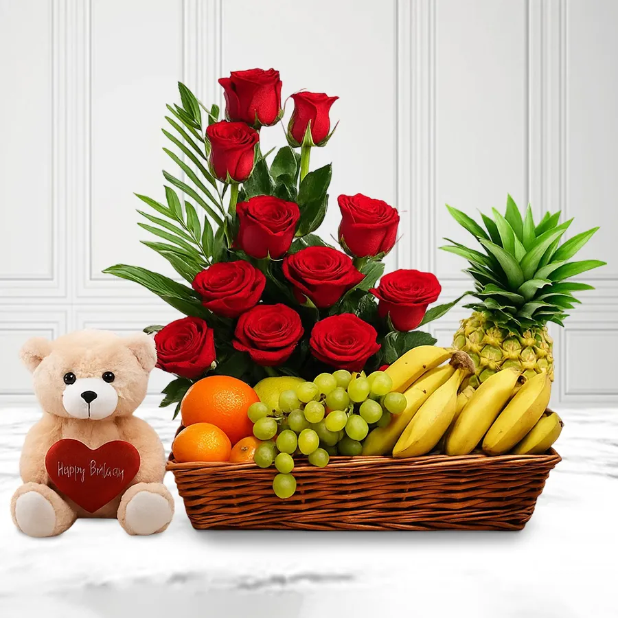 Joyful gift featuring a 2 kg fruit basket, 6-inch teddy bear, and 12 red roses arrangement.