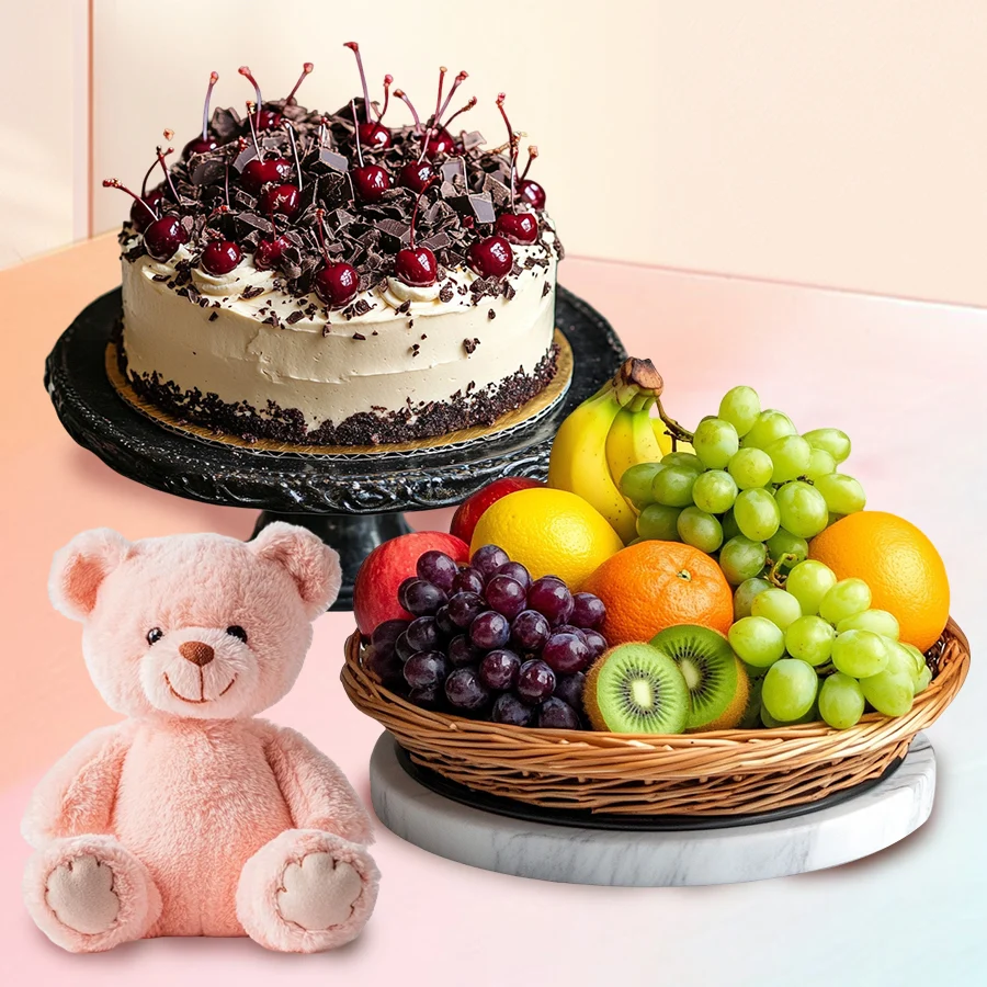 Black Forest cake with teddy bear, candles, and fresh fruit basket.