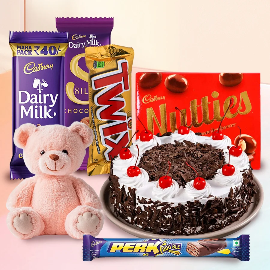 Black Forest Cake with a teddy bear and assorted Cadbury chocolates, a perfect gift for special occasions.