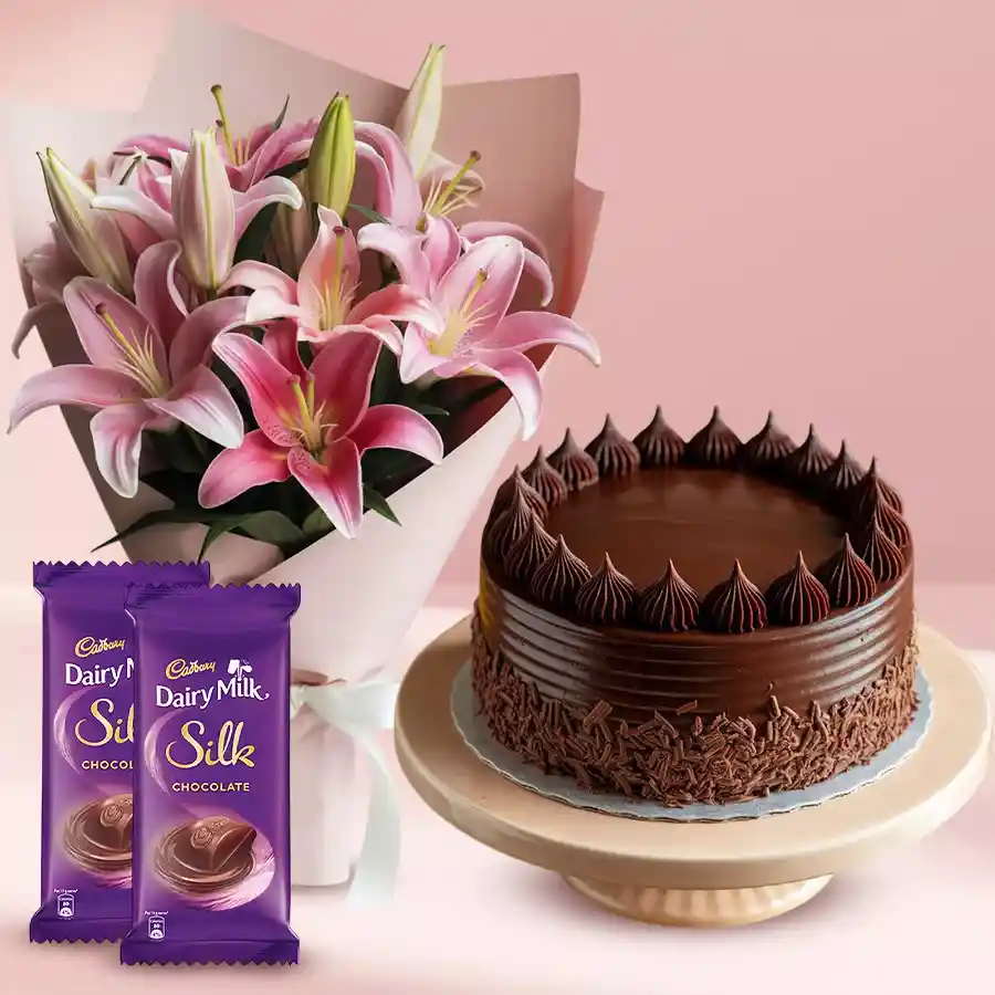 Sweet Indulgence Trio featuring Dairy Milk Silks, Lilies Bouquet, and Chocolate Cake for special midnight delivery.