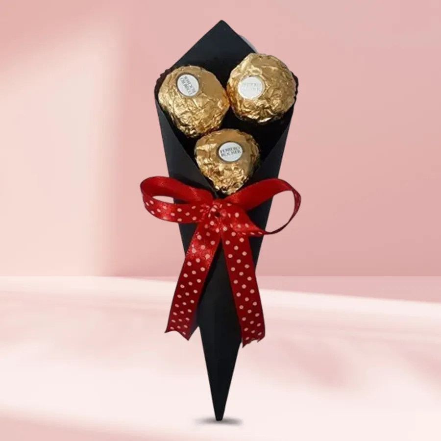 Three Ferrero Rocher chocolates arranged in a stylish cone, beautifully presented for gifting.