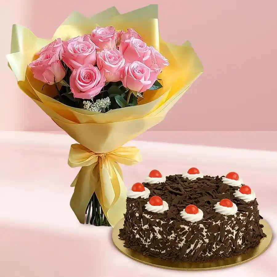 A beautiful bouquet of 12 pink roses tied with a pink ribbon alongside a round Black Forest cake, perfect for special occasions.