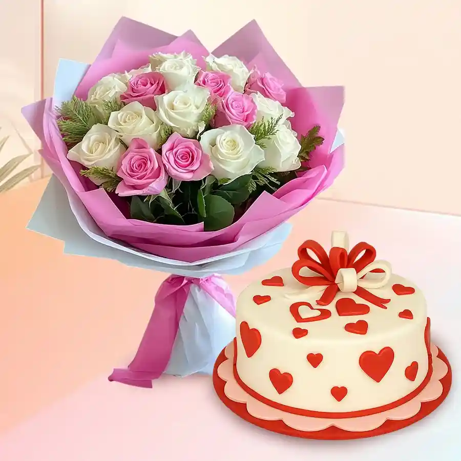 A stunning arrangement of 12 white and pink roses alongside a round strawberry fondant cake, perfect for any celebration.
