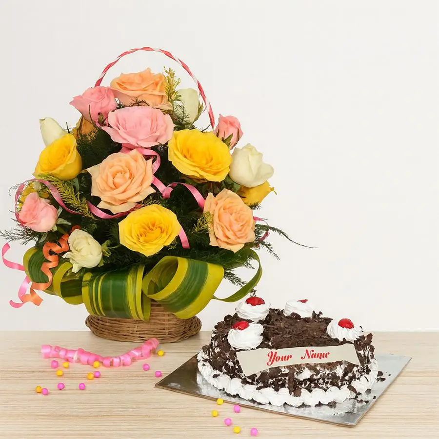 A beautiful arrangement of 24 mixed roses in a basket alongside a round Black Forest cake, perfect for gifting on special occasions.