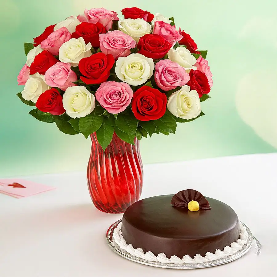 A stunning arrangement of 36 mixed roses in a vase accompanied by a round chocolate cake. Perfect gift for any occasion.