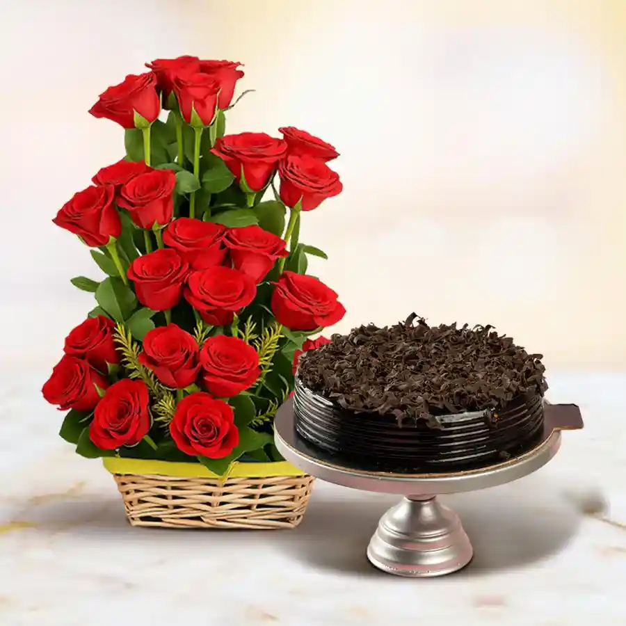 A basket filled with 50 red roses alongside a round chocolate cake.
