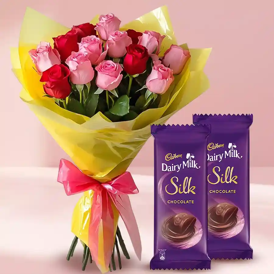 A vibrant bouquet of mixed roses accompanied by Cadbury Dairy Milk Silk chocolates, perfect for celebrations.