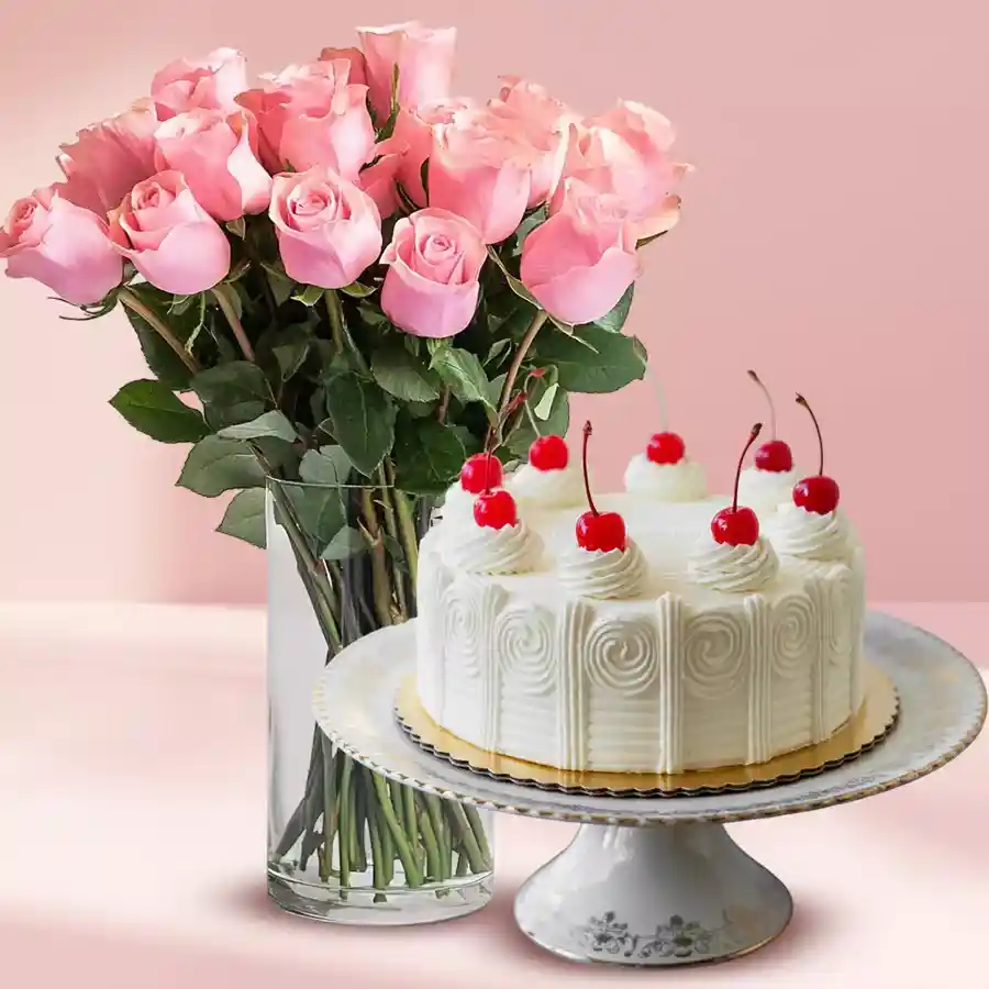 Dazzling pink roses in a vase paired with a white forest cake.