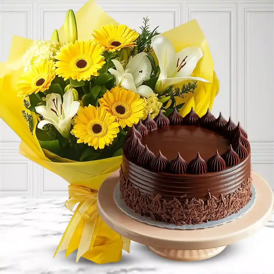 A vibrant bouquet of yellow gerberas and lilies paired with a delicious chocolate cake, perfect for gifting.