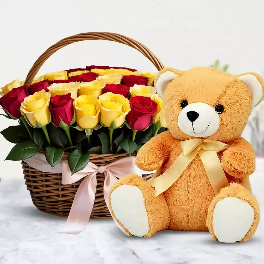 Cheerful basket of yellow and red roses with a cute brown teddy bear.