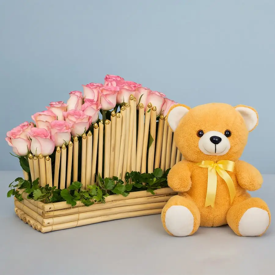 Cupid-design basket of pink roses with a soft brown teddy.