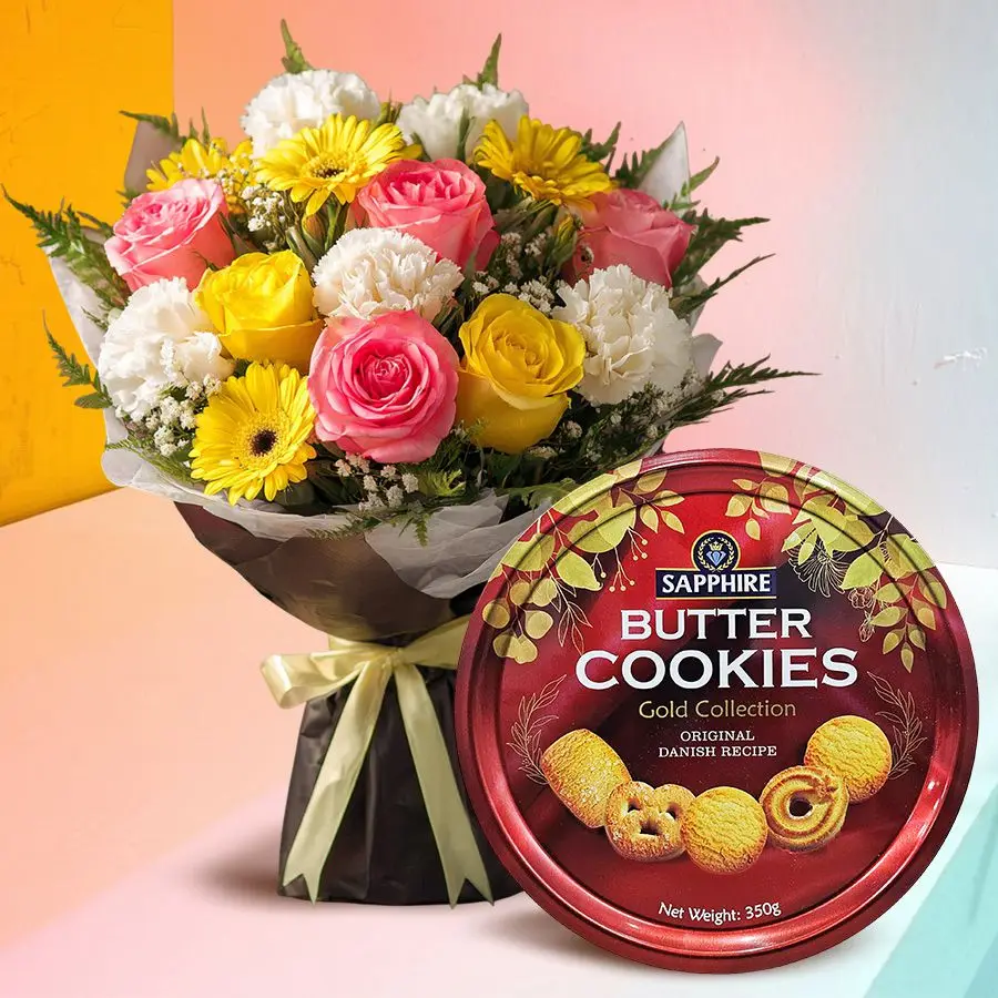 A vibrant mixed flowers bouquet with pink roses, yellow gerberas, and white carnations, accompanied by a box of Danish butter cookies.