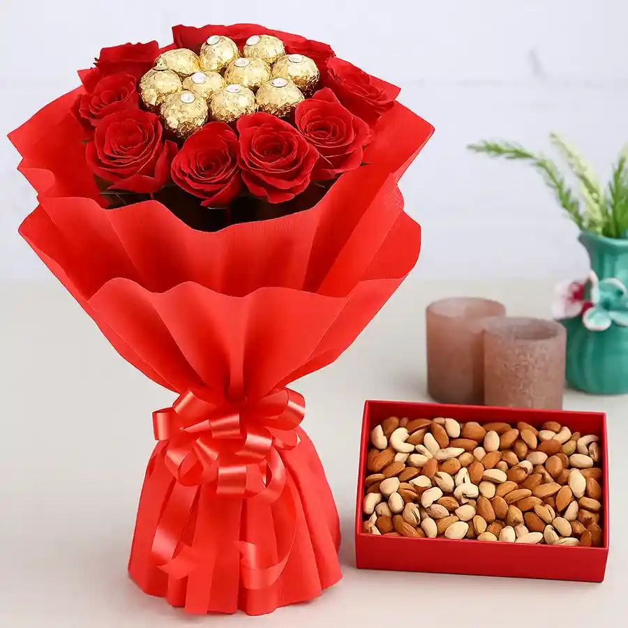 A charming Mother's Day gift featuring a bouquet of red roses, Ferrero Rocher chocolates, and a box of mixed dry fruits, beautifully wrapped.