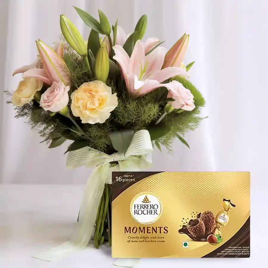 Floral arrangement with pink roses, pink lilies, white carnations, and Ferrero Rocher chocolates for Mother's Day.