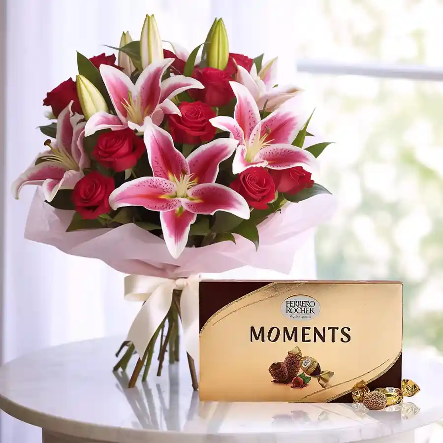 A stunning bouquet featuring lilies and roses, accompanied by a Ferrero Rocher chocolate box for Mother's Day.