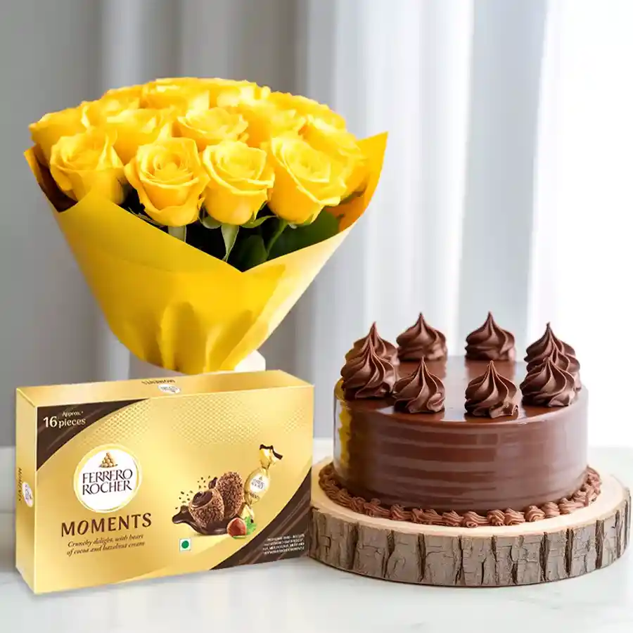 A delectable chocolate cake accompanied by a bouquet of yellow roses and a box of Ferrero Rocher chocolates, perfect for Mother’s Day.