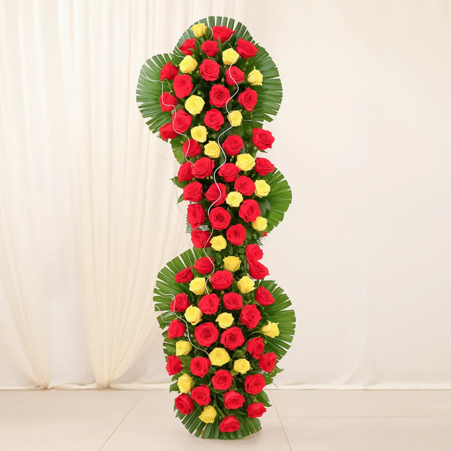 A tall arrangement of 100 super roses paired with a Cadburys Celebration pack, creating a beautiful gift combination for any occasion.