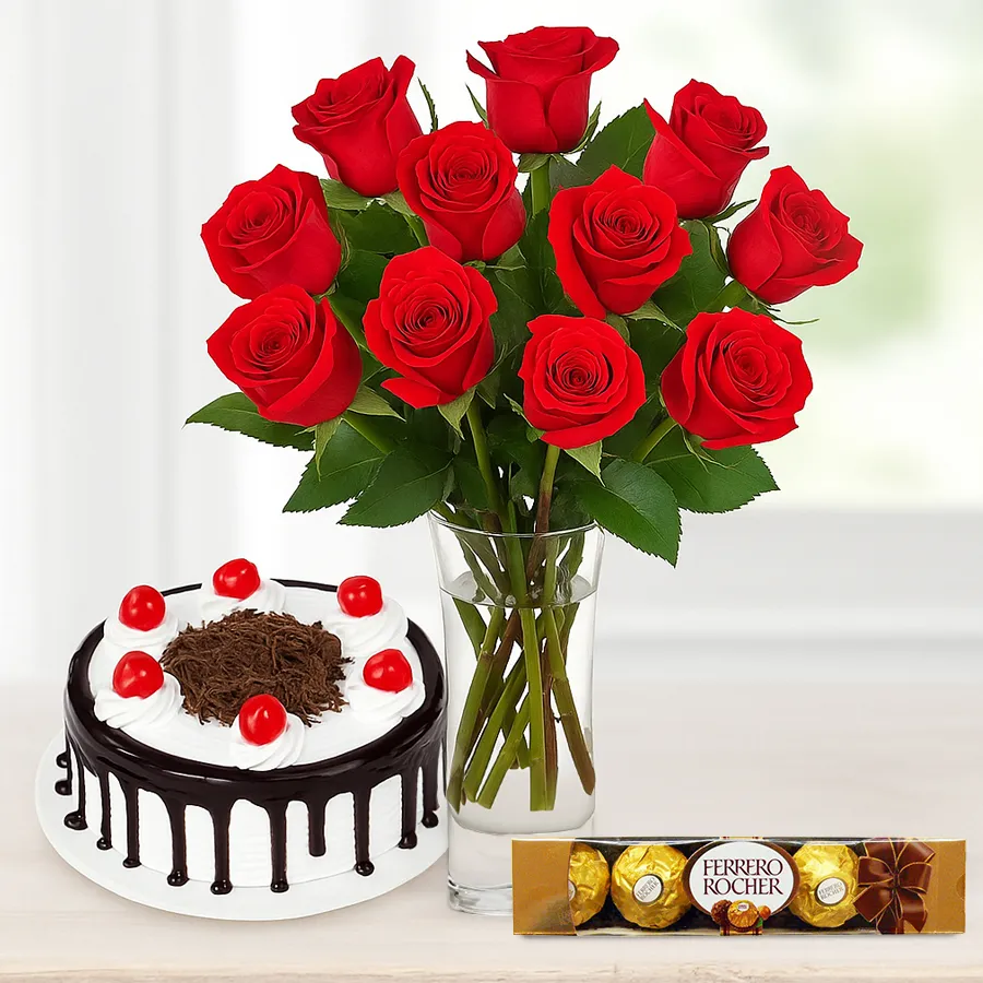 Gorgeous bouquet of red roses alongside a Black Forest cake and Ferrero Rocher chocolates making a perfect romantic gift.