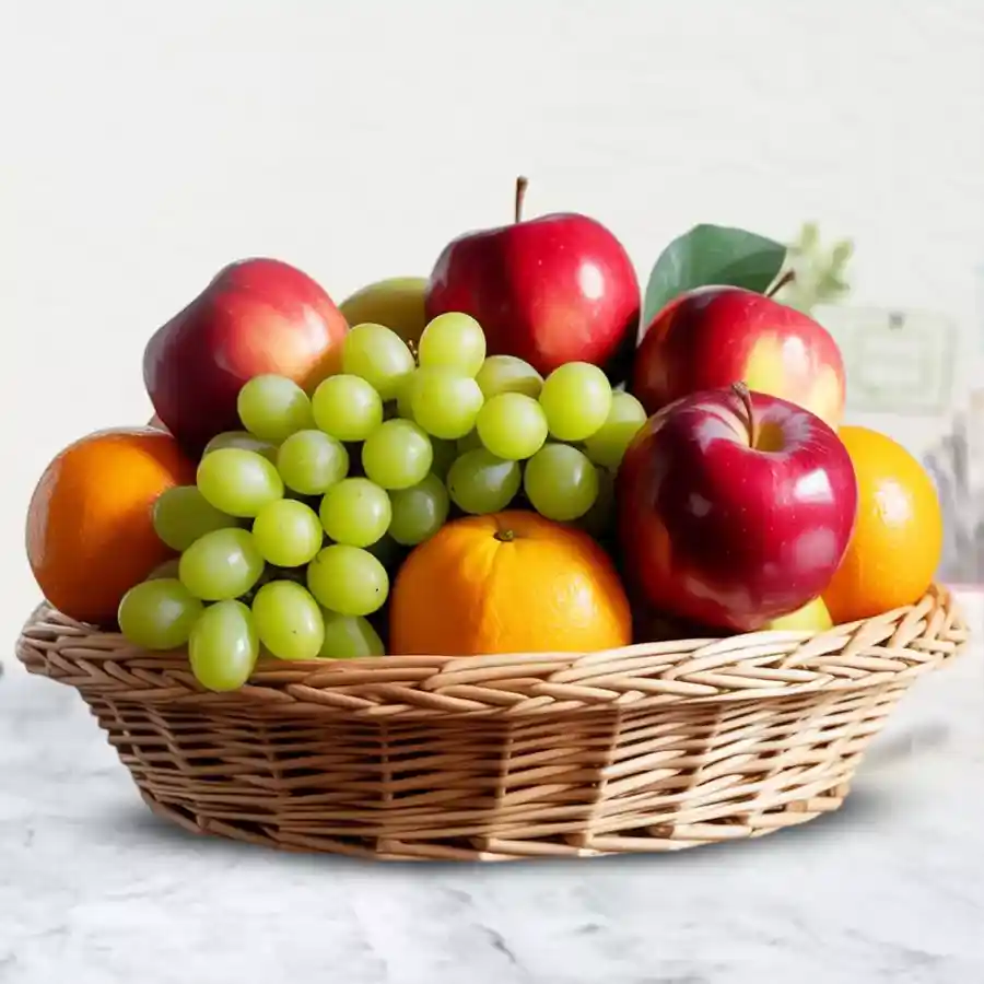A vibrant 2 Kg Fresh Fruits Basket with apples, grapes, and oranges, symbolizing freshness and affection.