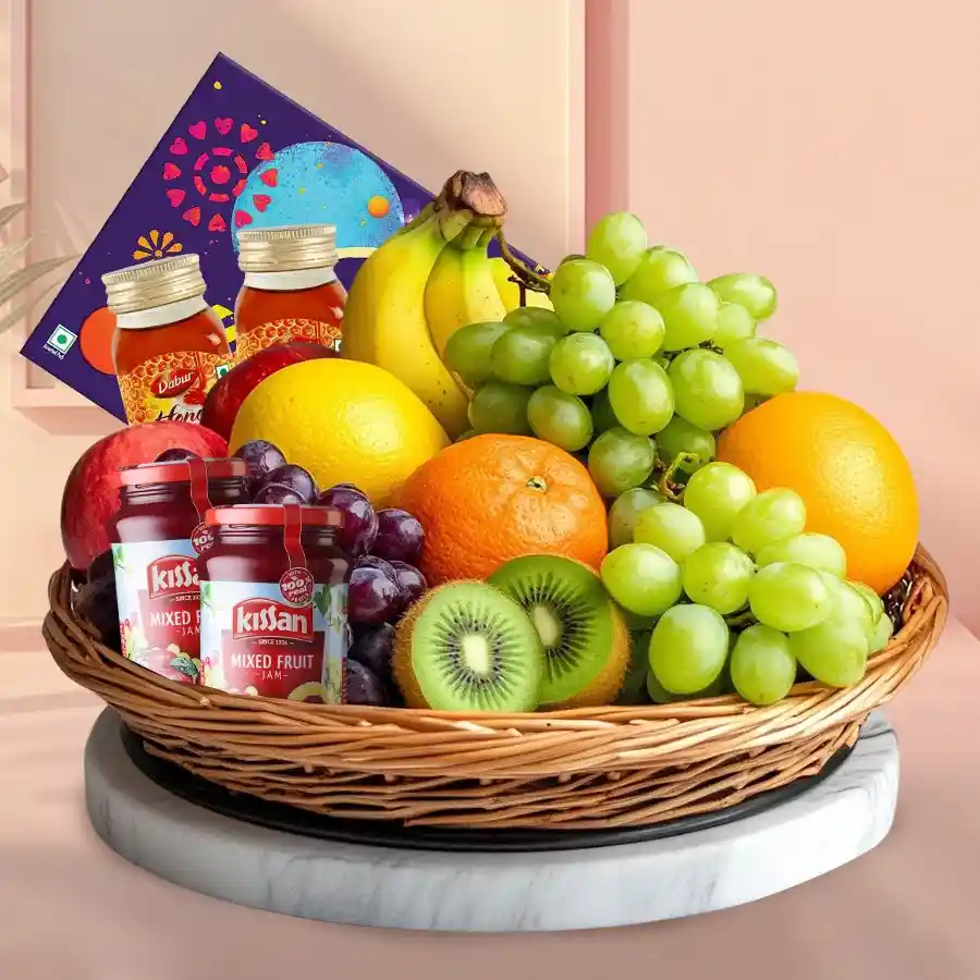 Nourishing Mother’s Day gift basket featuring fresh fruits, jams, honey, and a Cadbury celebration pack.