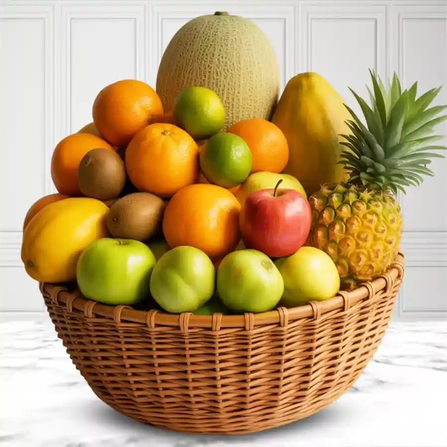 A beautifully arranged basket filled with fresh fruits like Musk Melon, apples, and pineapple, ideal for gifting on Mother's Day.