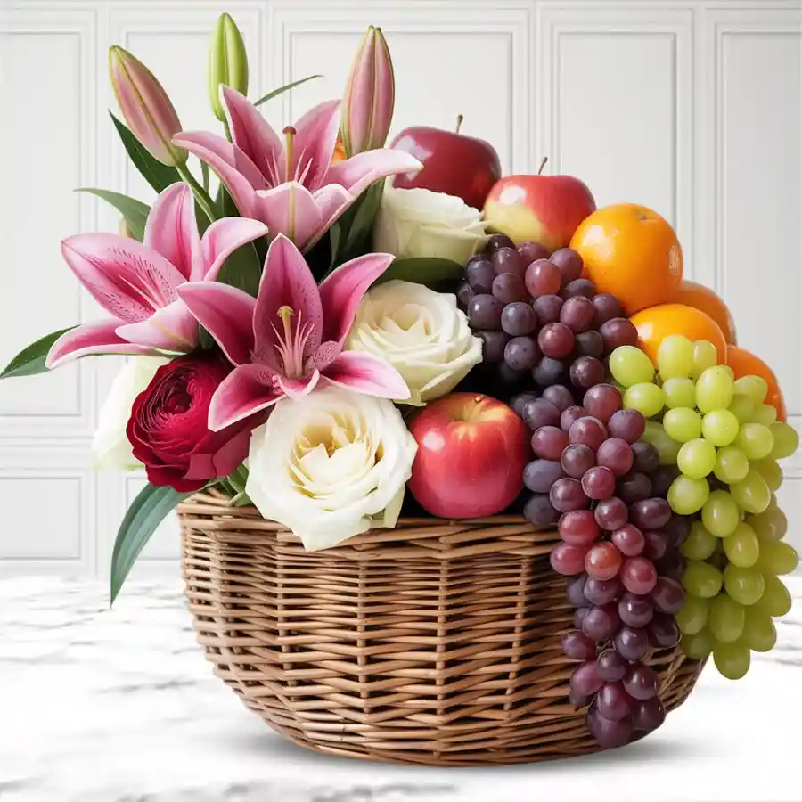 A beautiful basket featuring fresh fruits, pink lilies, and pink and white roses for Mother's Day.