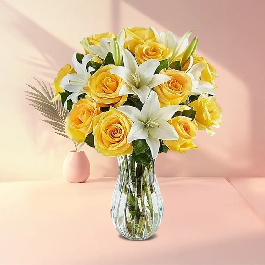 Elegant vase filled with bright yellow roses and white lilies.
