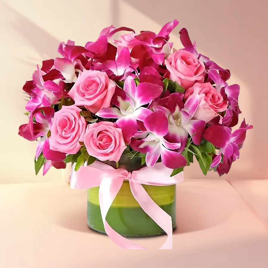 Elegant arrangement of pink roses and purple orchids, perfect for gifting and expressing love.
