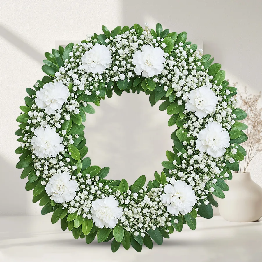 Heartfelt wreath of 15 vibrant carnations, symbolizing remembrance and appreciation.