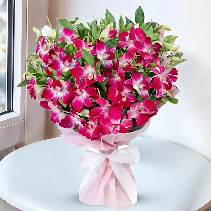 Exquisite bouquet featuring 12 long-stem orchids elegantly wrapped in tissue.