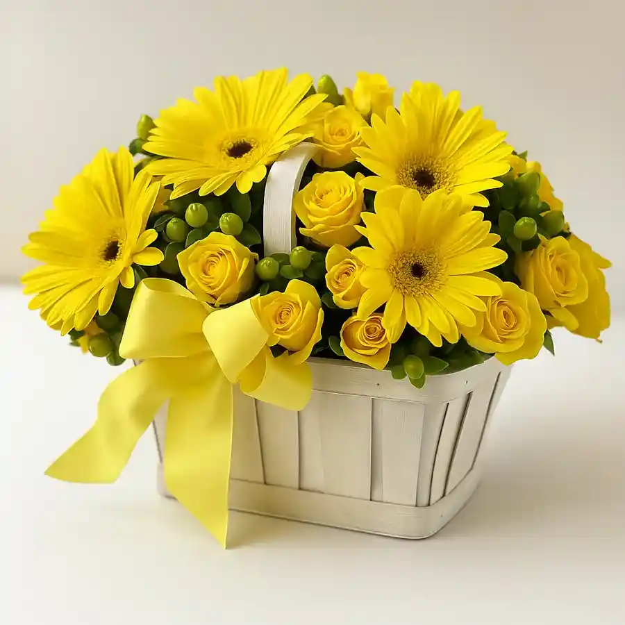 A vibrant Sunshine Blossom Basket featuring 15 yellow roses and 5 gerberas, beautifully arranged in a charming basket.