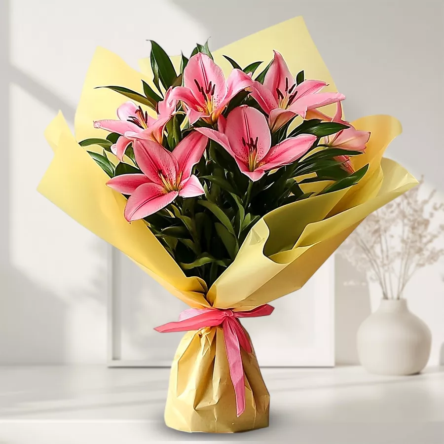 Vibrant bouquet of five pink lilies designed to welcome a new bride.