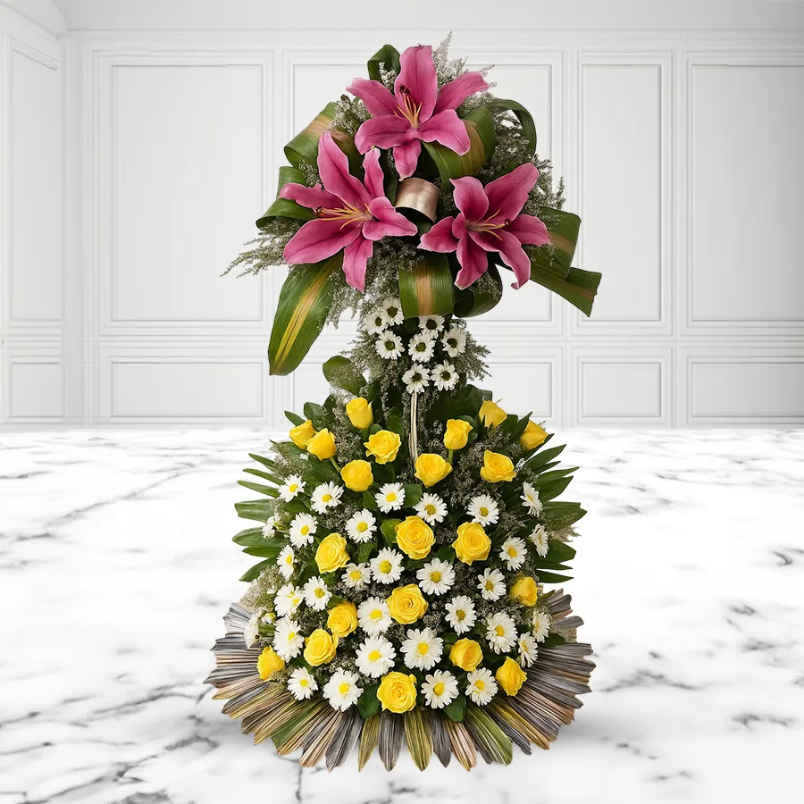 Stunning two-tier floral arrangement with pink lilies, yellow roses, and white chrysanthemums, wrapped in love.