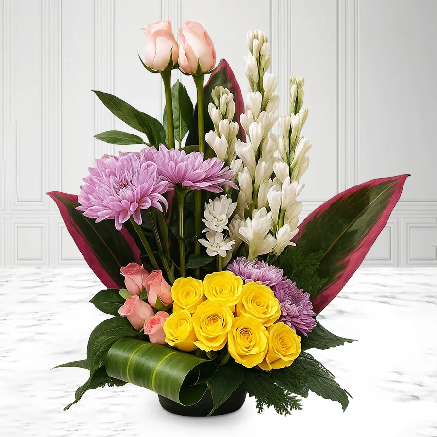 Vibrant arrangement of 24 assorted flowers including Gerberas, Pink Roses, Yellow Roses, and Tube Roses in a festive display.
