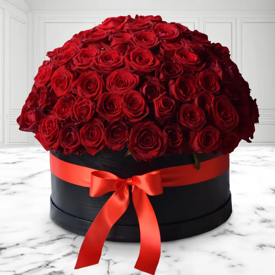 A stylish black hat box filled with 50 enchanting red roses, perfect for celebrating special occasions.