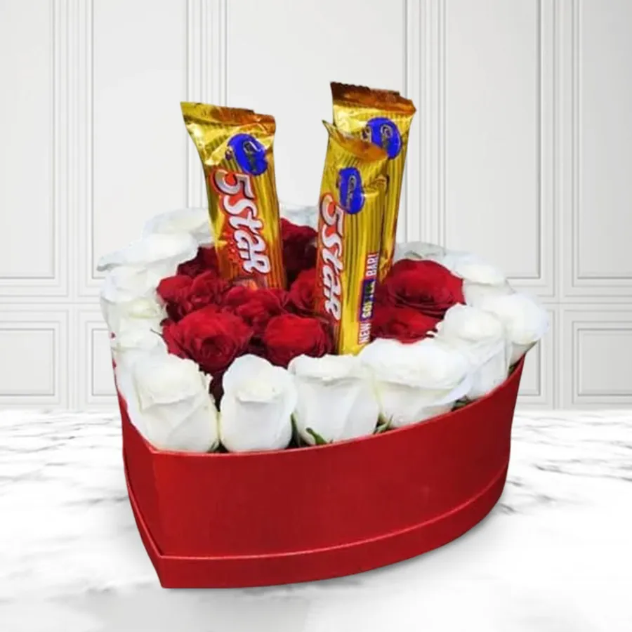 Heart-shaped box filled with white and red roses alongside Cadbury chocolates.