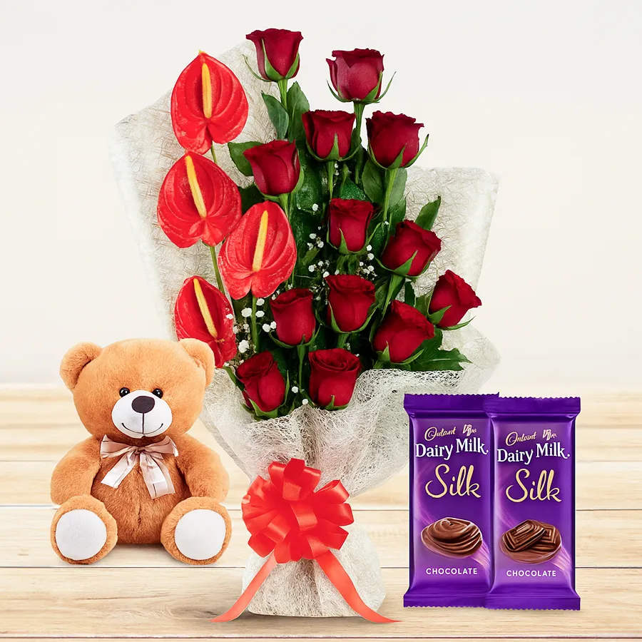Heartfelt gift of red roses, teddy bear, and chocolates.