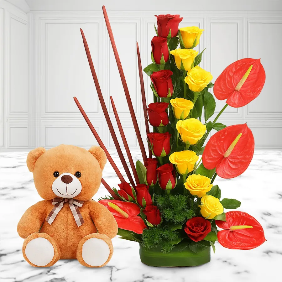 Lovely arrangement of roses and anthodium with a cute teddy bear.